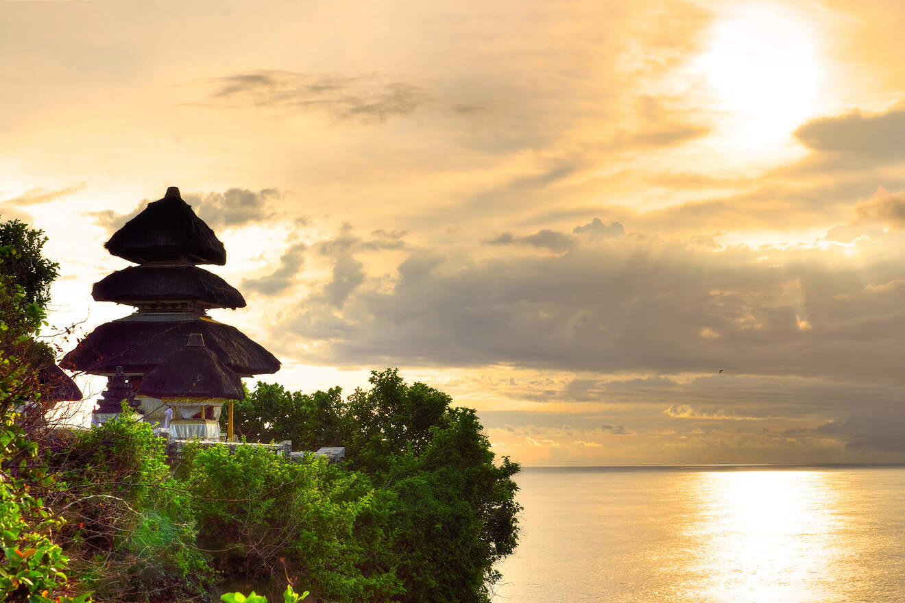 a view of a sunset over the ocean from a cliff